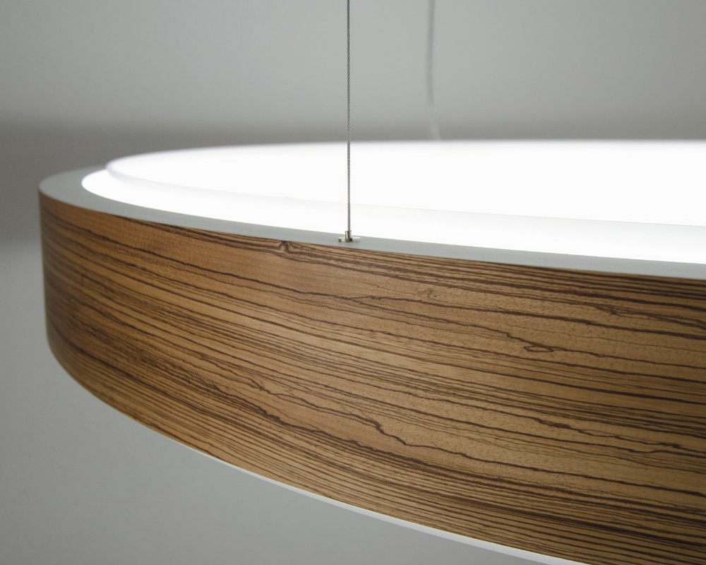 Special surfaces possible (like hand-polished or wood veneer) Detail of a large ring light CIRCOLO with elegantly moulded wood veneer on an outer radius.
