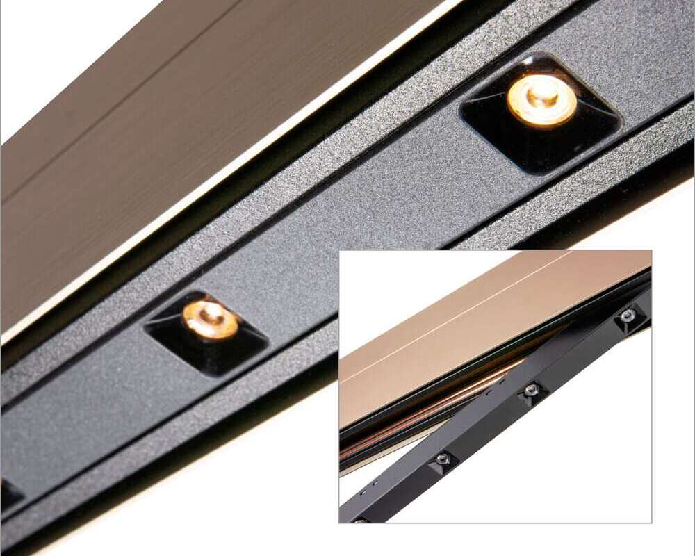 Linear lens light element for PALADIO TRACK Close-up of PALADIO TRACK track light in bronze with a light insert with small lenses, with another small picture of it placed on top, with the light insert still clicked out.