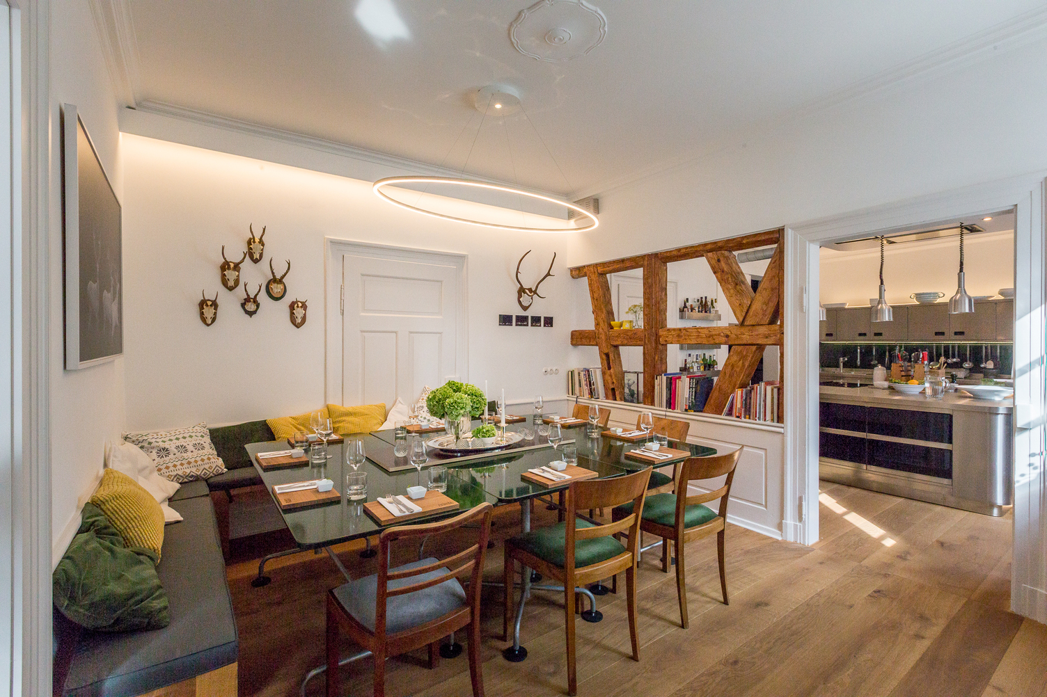 SLIM ELLIPSE elliptical ring light above the dining table Large, elliptical SLIM ELLIPSE pendant light by SATTLER hovers over an elegantly set dining table in Andrea Lange Cooking School.