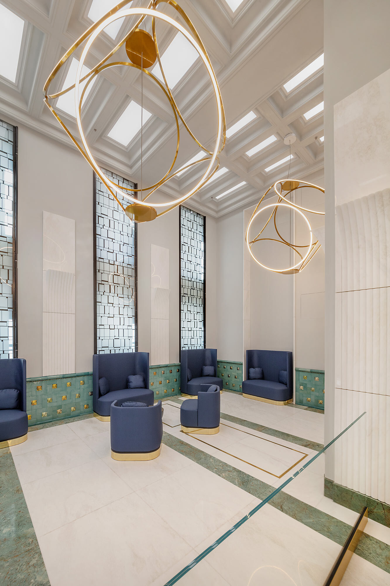 Luxurious seating area in the Postpalast, Budapest, with blue seating and Sattler's Unione 1750 lighting fixtures.