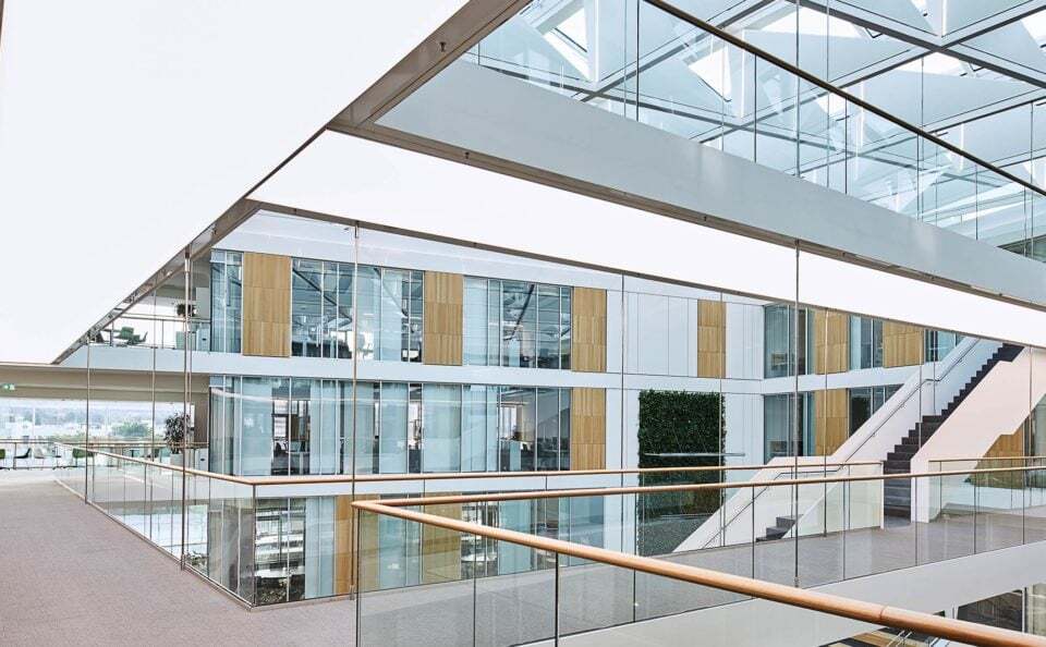 Illuminated walkways in the modern stairwell of the Sartorius office building, the underside of each staircase illuminates the corridor below.