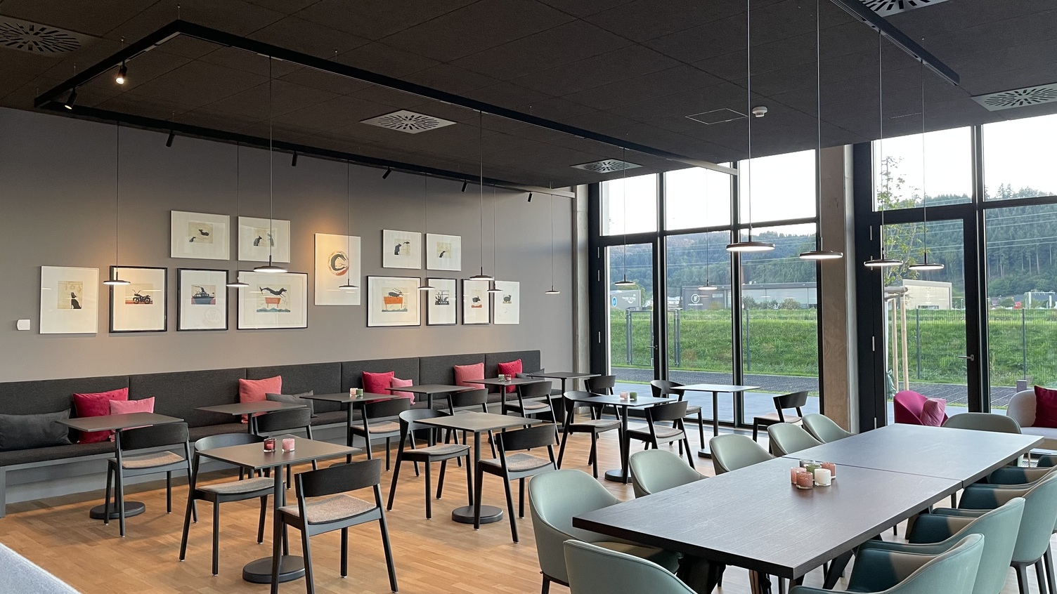 Streit Cafeteria - Featuring Avveni Pendant Lights by Sattler Cafeteria area at Streit with modern seating and Sattler's Avveni Pendant lights and Evolution Spot are each used in Paladio Track system lights.